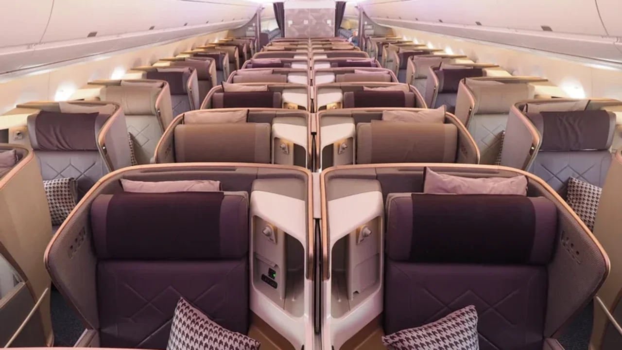 Singapore Airlines business class suite with full-height privacy doors and flat bed