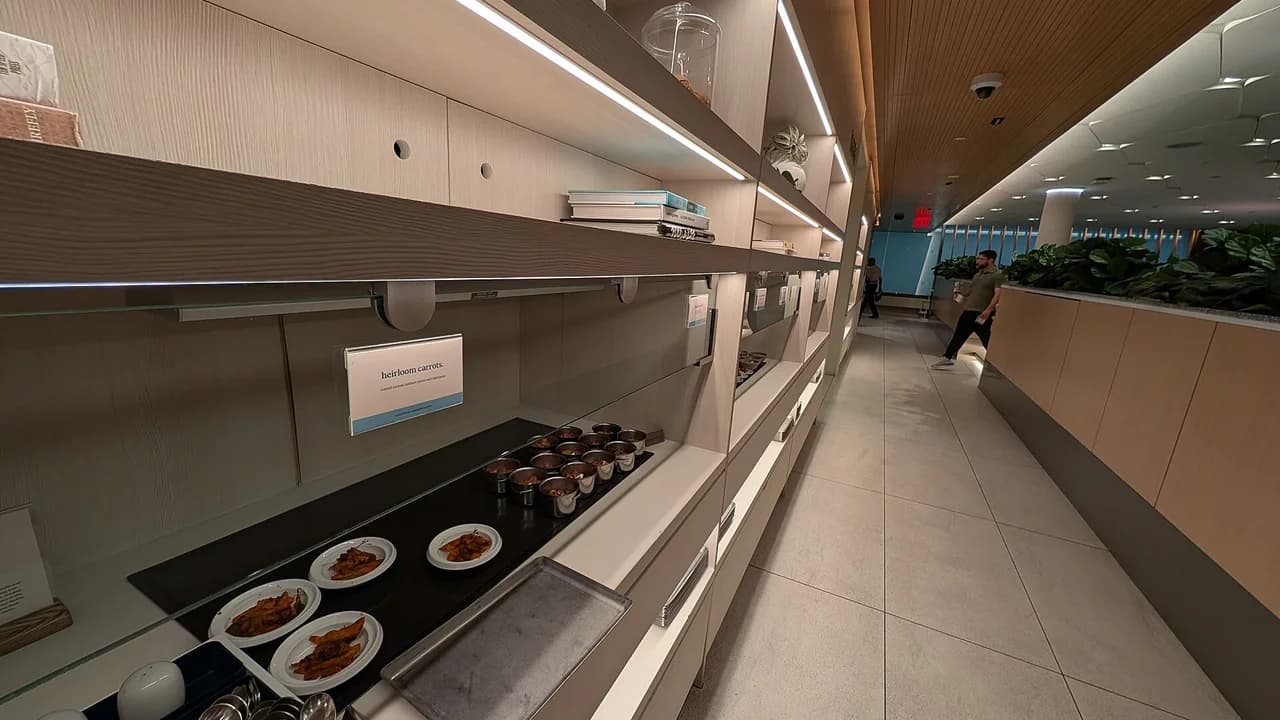 Airport lounge dining area with gourmet buffet before evening flight