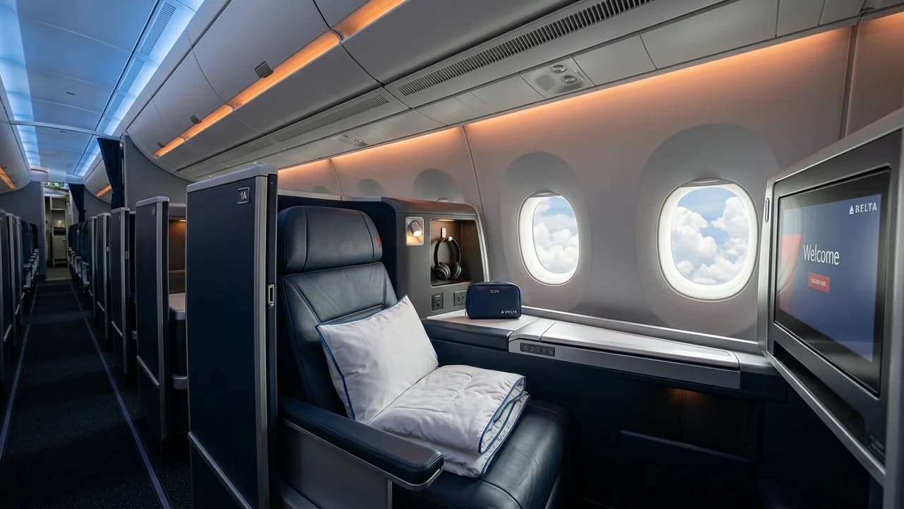 Delta business class cabin with lie-flat suite and premium amenities