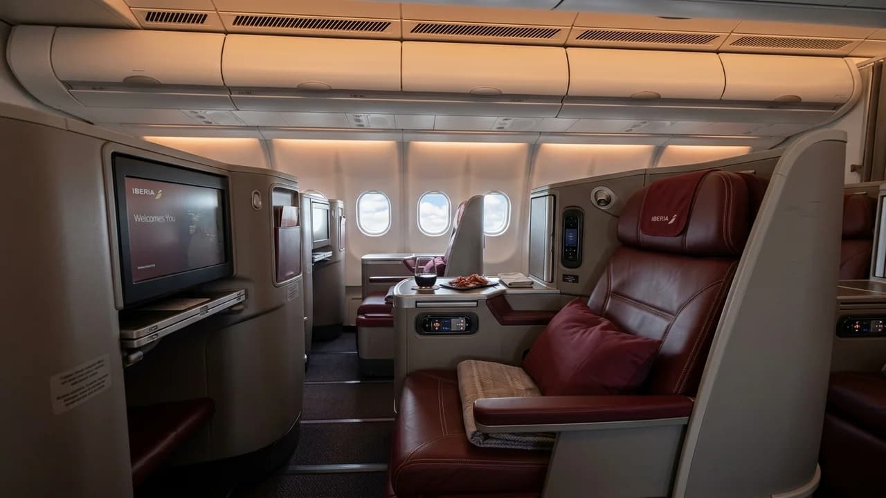 Iberia business class cabin with lie-flat suite and premium amenities