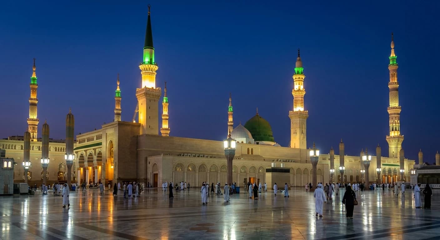 Al-Masjid an-Nabawi at night with illuminated minarets