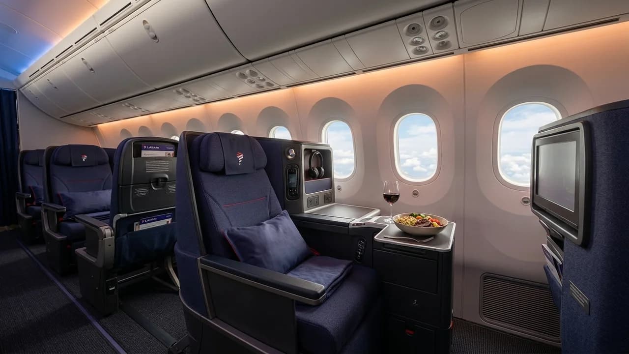 LATAM business class cabin with lie-flat suite and premium amenities